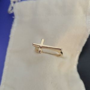 Gold cross ring.
